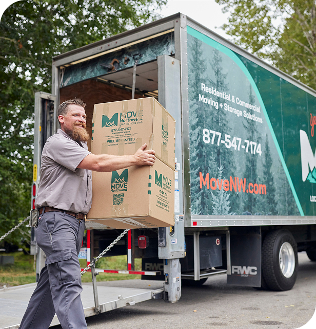 Move Northwest employee unloading branded Moving Boxes from a Moving Truck during a relocation.