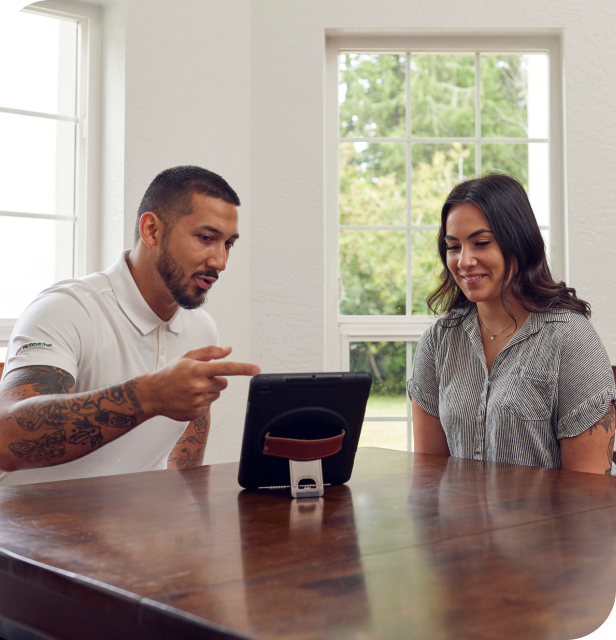 Move Northwest representative providing a Moving & Storage consultation to a customer using a tablet.